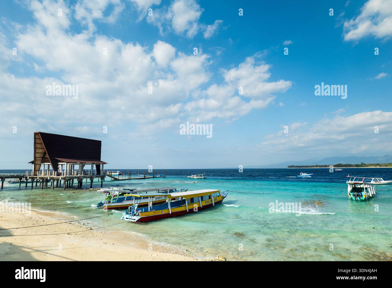 Gili Islands, Indonesia - 08.15.2023: Gili Island, Gili Meno, beautiful beach and boat jetty area view in Lombok, Bali, Indonesia. Stock Photo