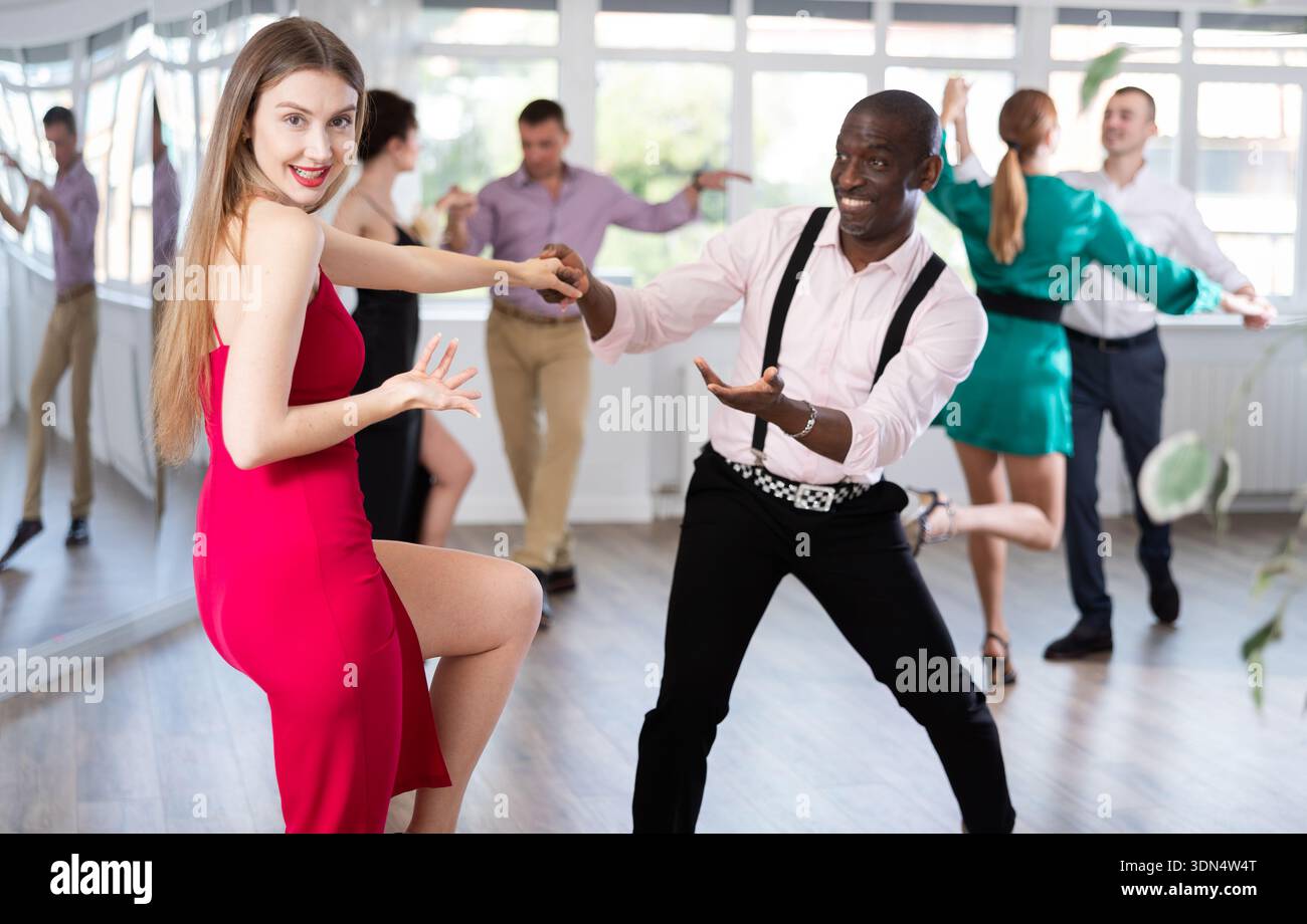 Man and woman practicing swing dance in dancing studio Stock Photo