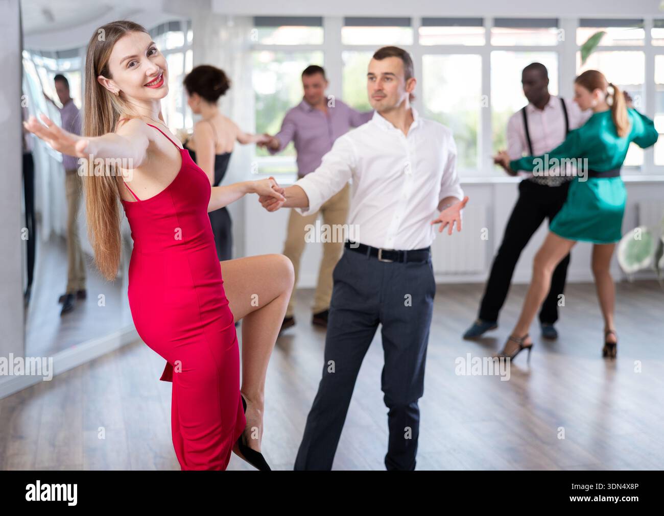 Man and woman practicing swing dance in dancing studio Stock Photo