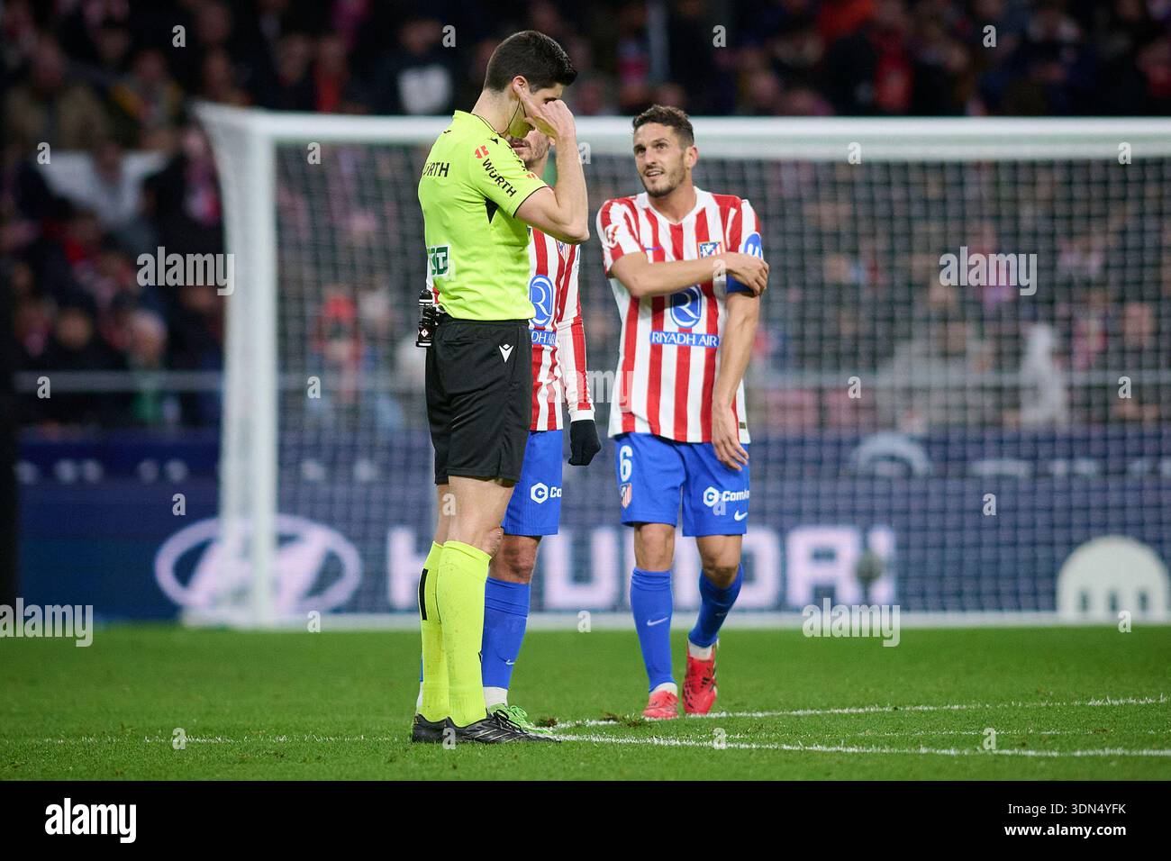Atletico de Madrid's Koke Resurreccion (R) and referee Mateo Busquets ...