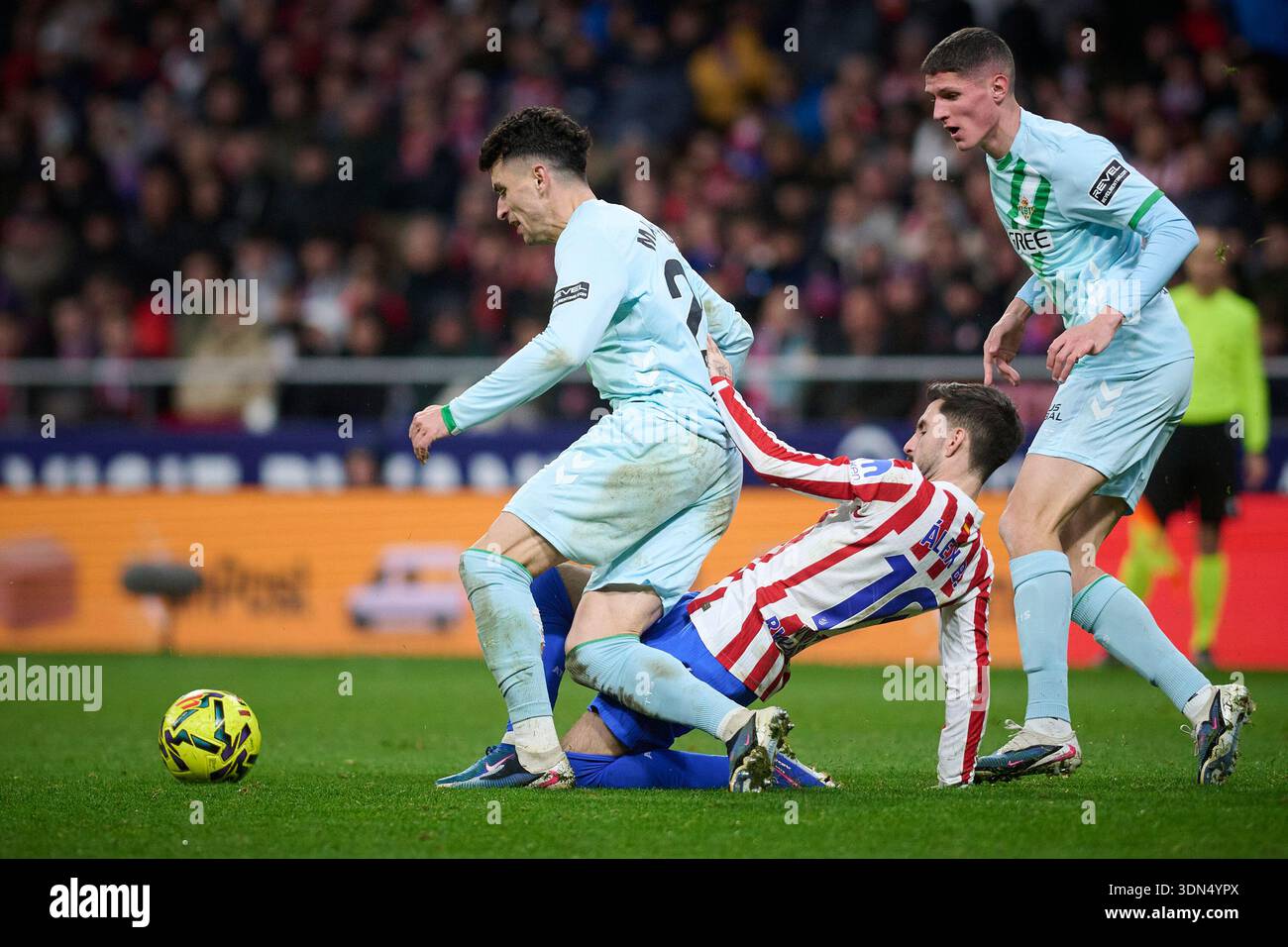 Atletico de Madrid's Alex Baena (C) and Real Betis Balompie's Marc Roca ...