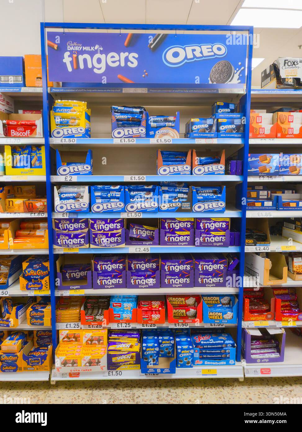 Cadbury dairy milk fingers and Oreo cookies on sale at Tesco supermarket in a display stand, UK. Concept: ultra processed foods, UPFs, Cadburys - Smartphone Captured Stock Image