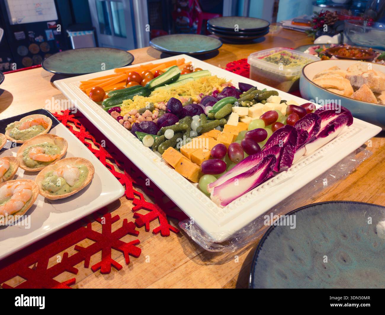 Bite size canapé finger food starters with plates set up on a kitchen table served as buffet style for a party at Christmas time. UK - Smartphone Captured Stock Image