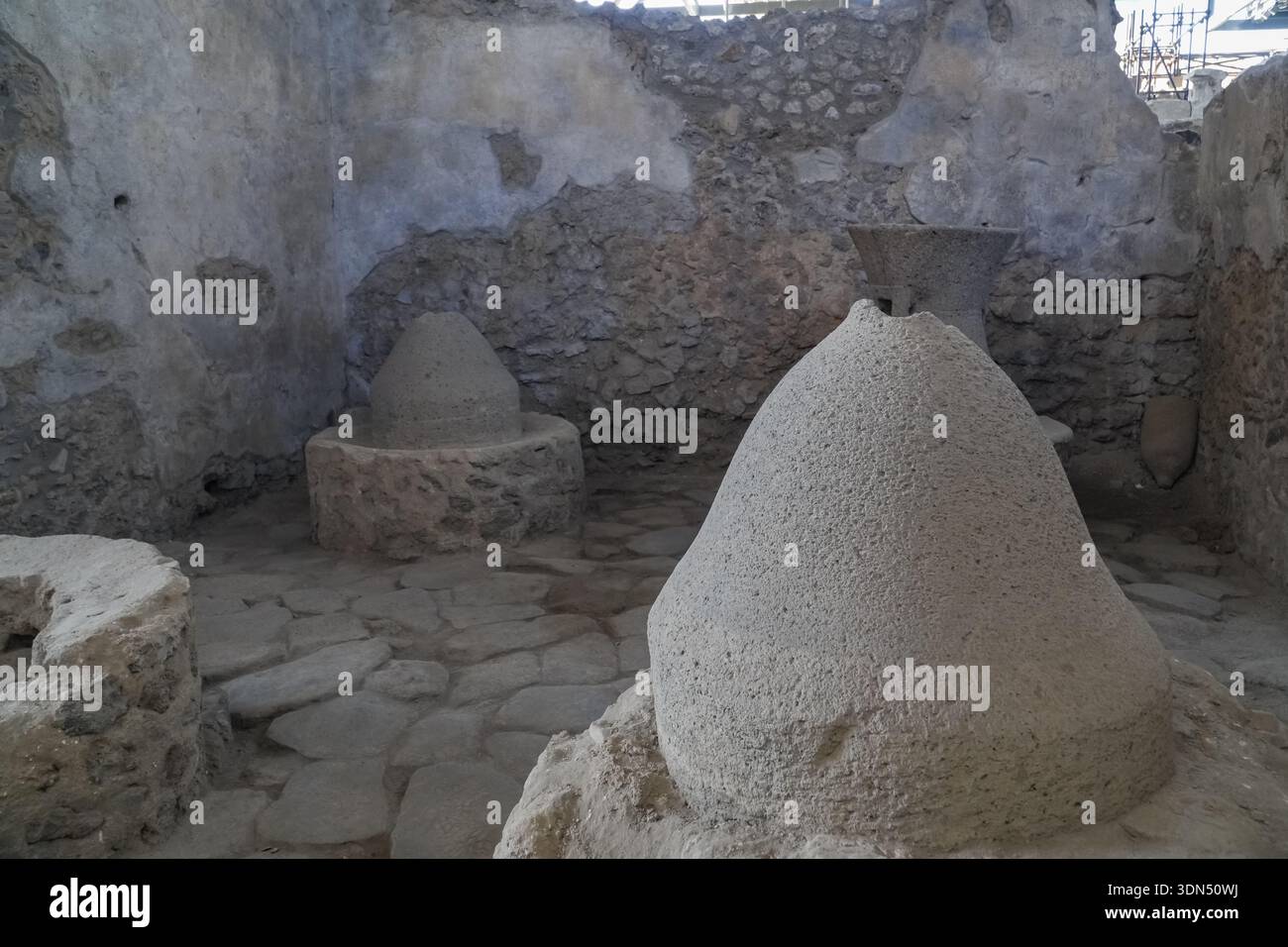 Roman millstones (*molae*) in the ruins of a *pistrinum* (bakery) in ...