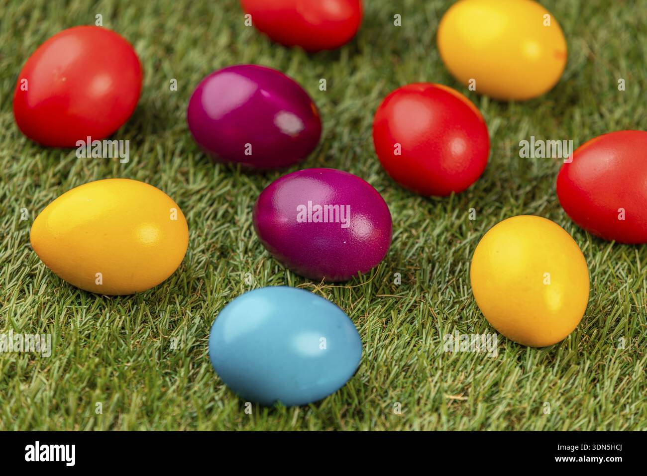 Colourful Easter eggs spread on green grass Stock Photo