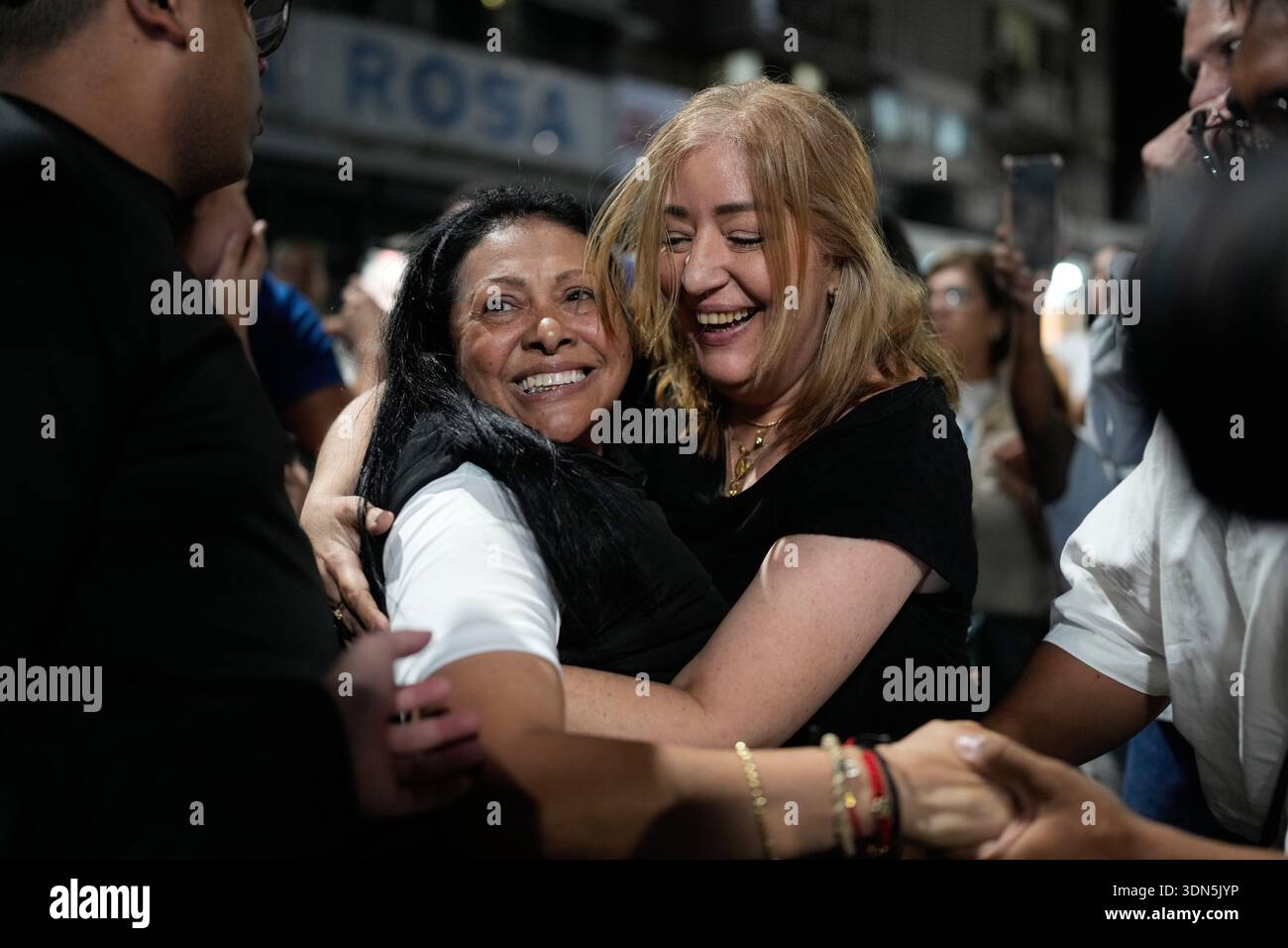 Political activist Dignora Hernandez, left, is embraced by an ...