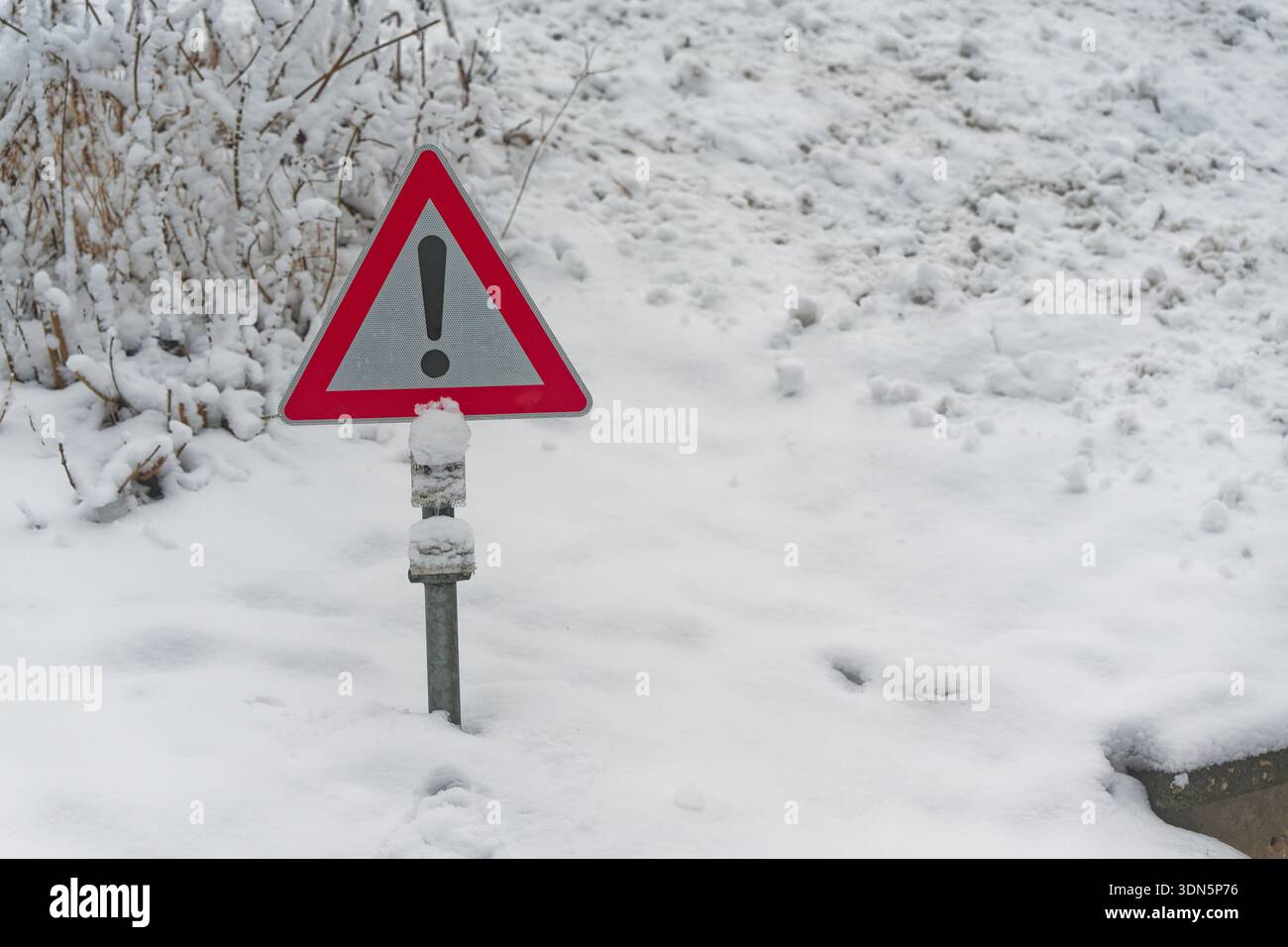 Red warning sign barely visible in deep snow during February 2026 ...