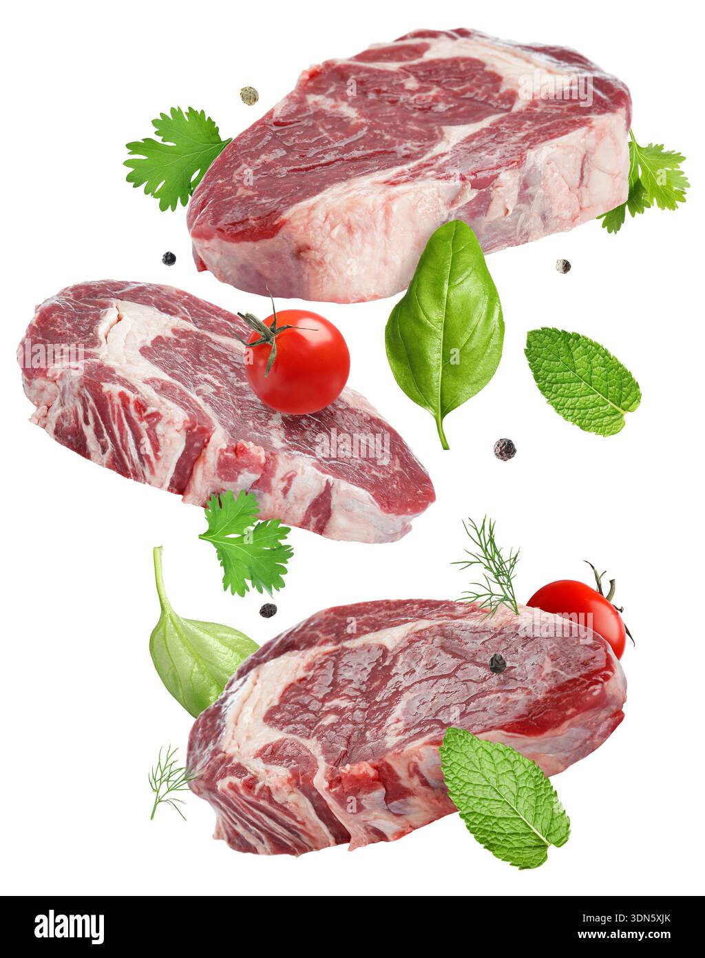 Fresh beef steaks falling on white background Stock Photo