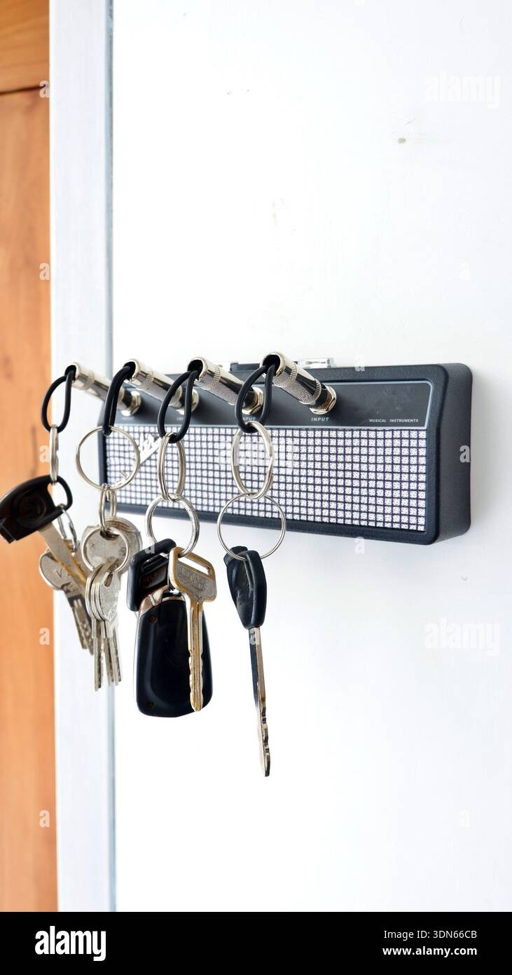 Creative Guitar Amp Key Holder with Jack Plug Keychains on White Wall Stock Photo