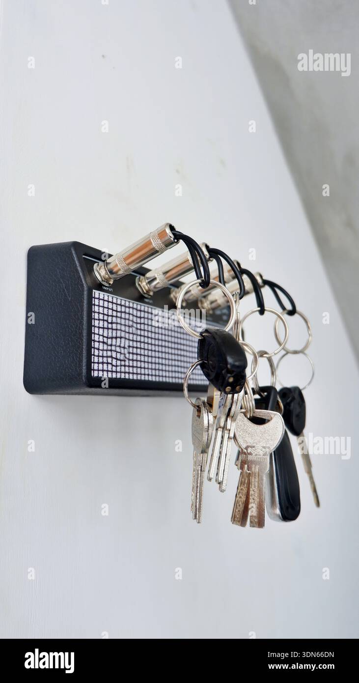 Creative Guitar Amp Key Holder with Jack Plug Keychains on White Wall Stock Photo