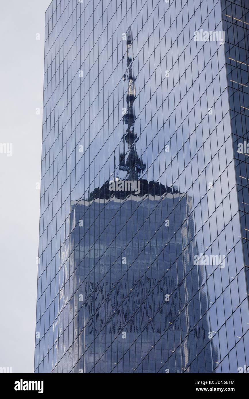 The iconic spire of One World Trade Center reflected in the glass ...