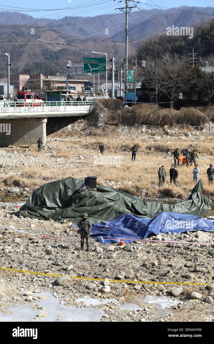 Chopper crash Military personnel examine the site of an AH-1S Cobra ...