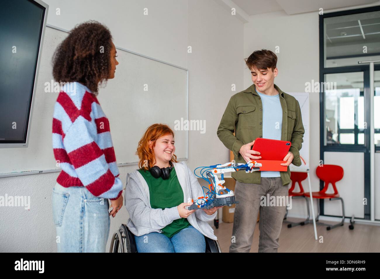 Inclusive student team presenting technology project in class. Stock Photo