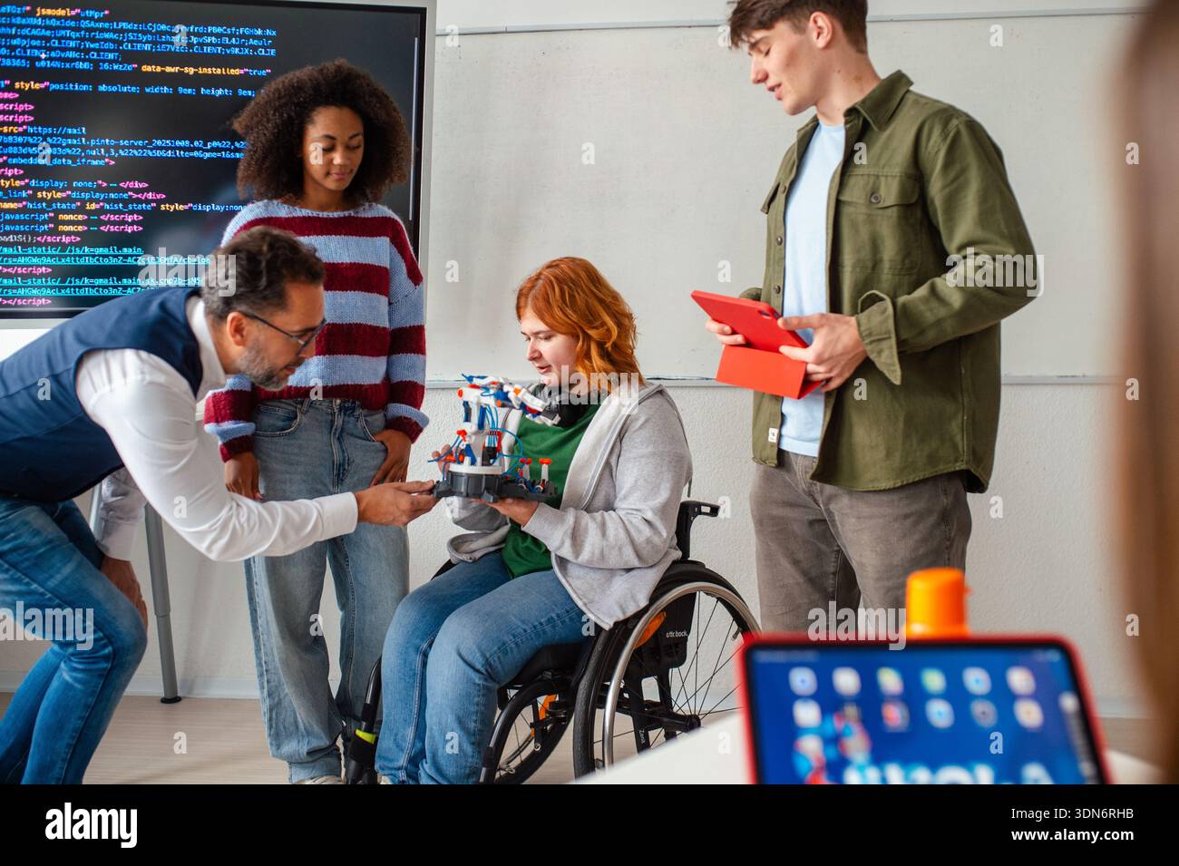 Inclusive student team presenting technology project in class. Stock Photo