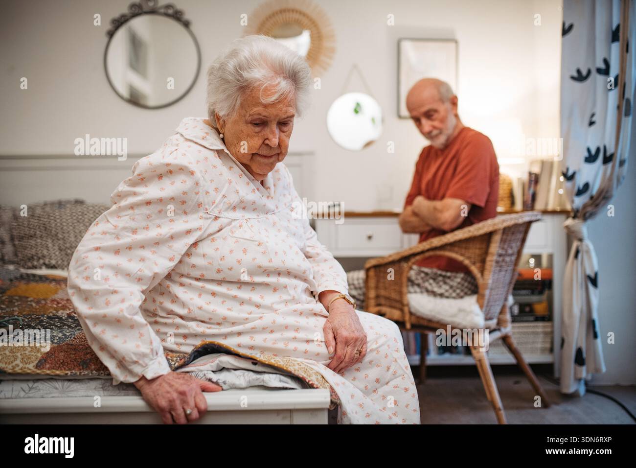 Elderly spouses sharing quiet moment before sleep. Stock Photo