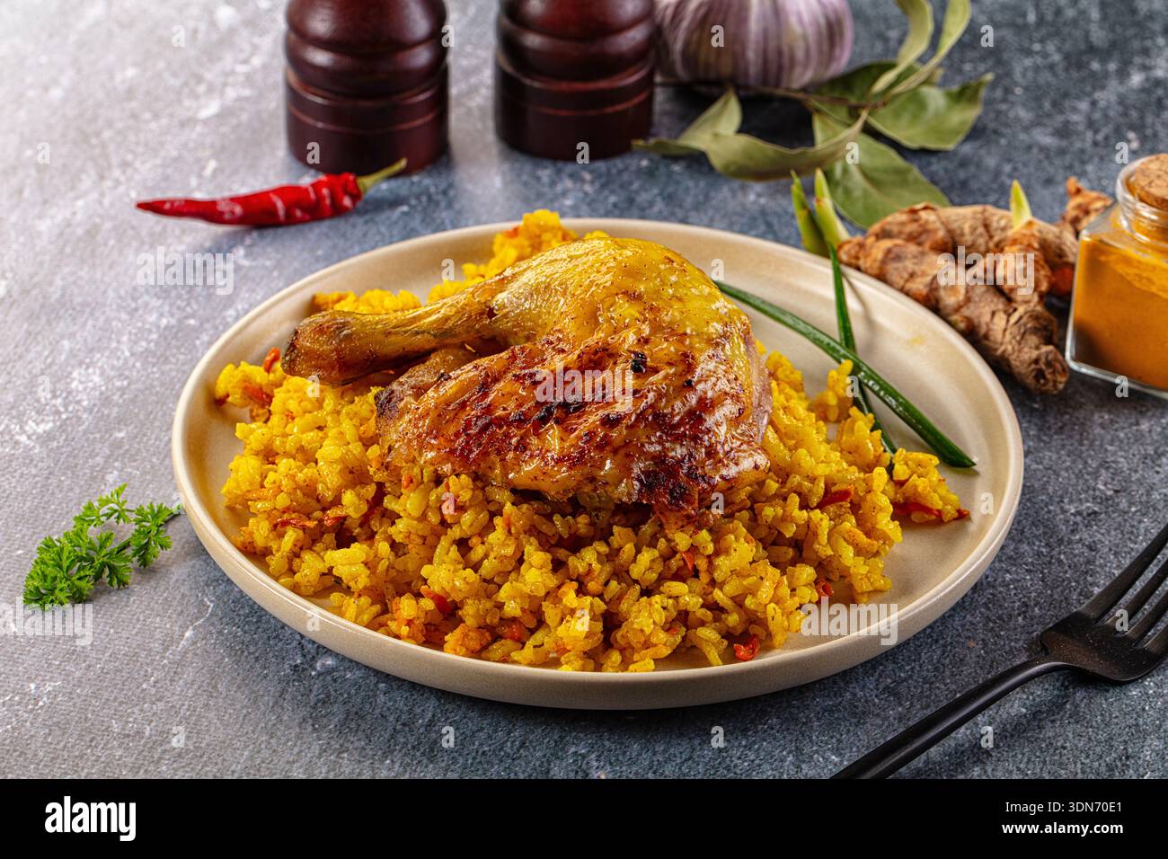 Roasted chicken leg with yellow curry rice Stock Photo - Alamy