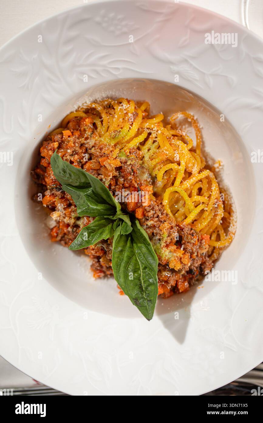 Spaghetti bolognese with basil in white plate Stock Photo