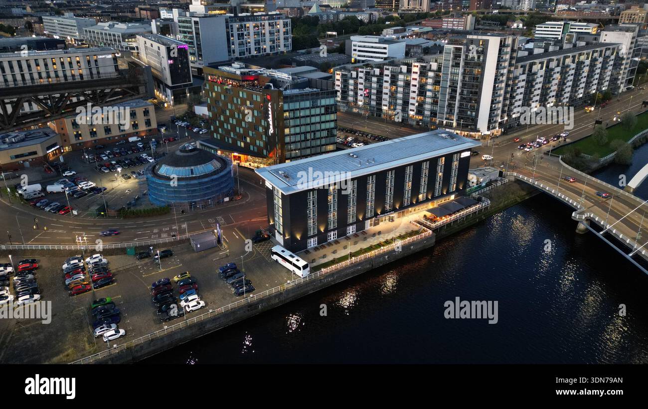 Aerial drone view of the Radisson RED hotel and SEC Armadillo beside the River Clyde near the Clyde Arc bridge in Glasgow, Scotland, United Kingdom at Stock Photo