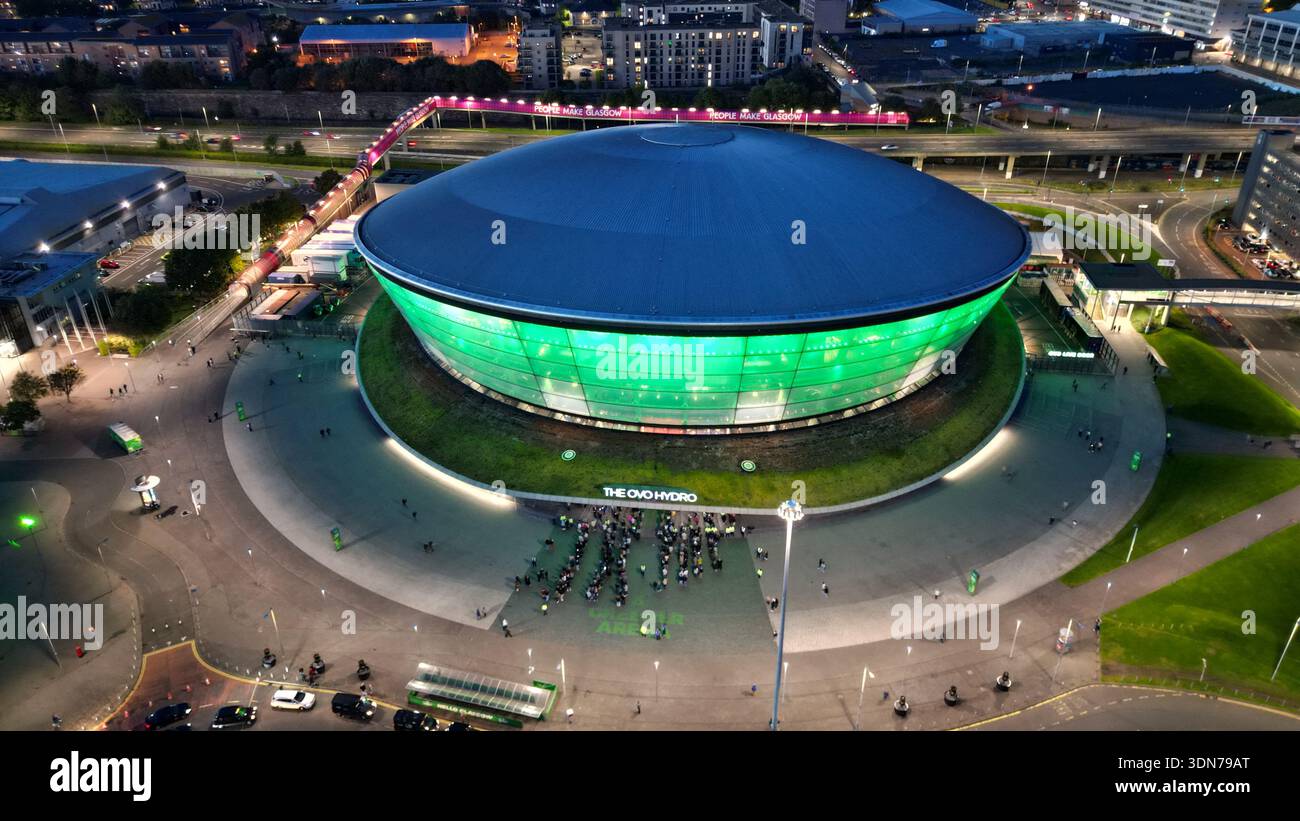 Aerial drone view of the OVO Hydro arena illuminated green at dusk beside the River Clyde in Glasgow, Scotland, United Kingdom. Stock Photo