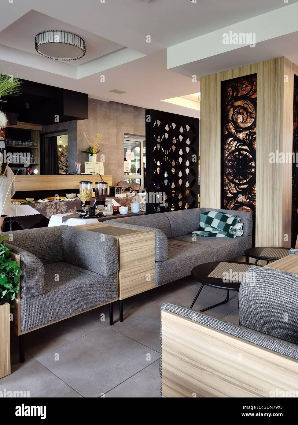 Modern hotel lobby lounge with comfortable seating and buffet area - Smartphone Captured Stock Image