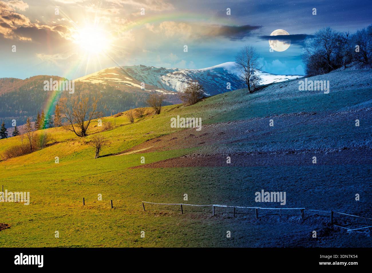 remote mountainous rural landscape on spring equinox. day and night time change concept. arable and trees on steep slope in green grass with sun and m Stock Photo
