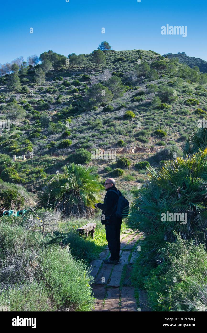 Man walking through the mountains Stock Photo