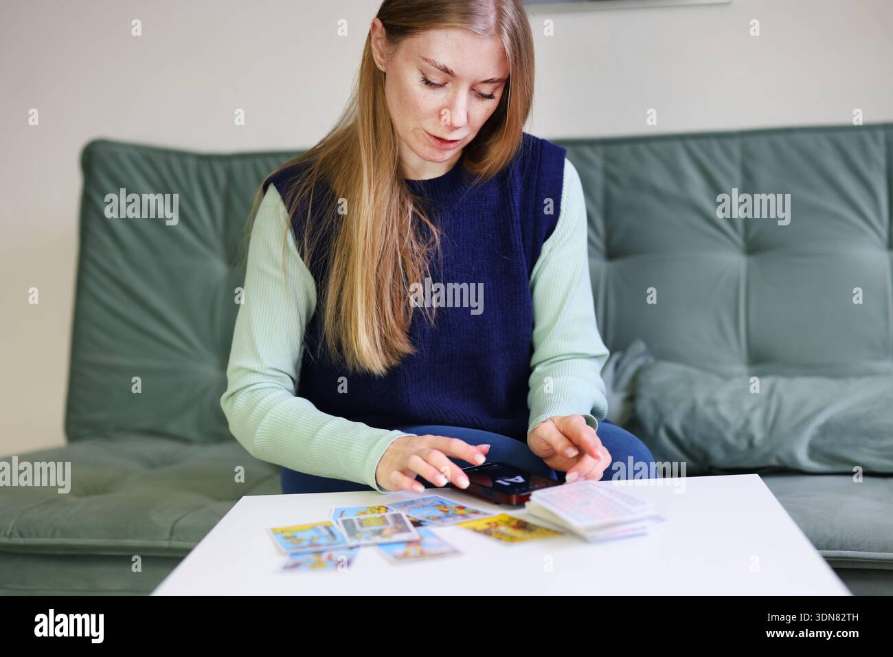 Tarot cards spread analyzed by AI technology on mobile phone Stock Photo