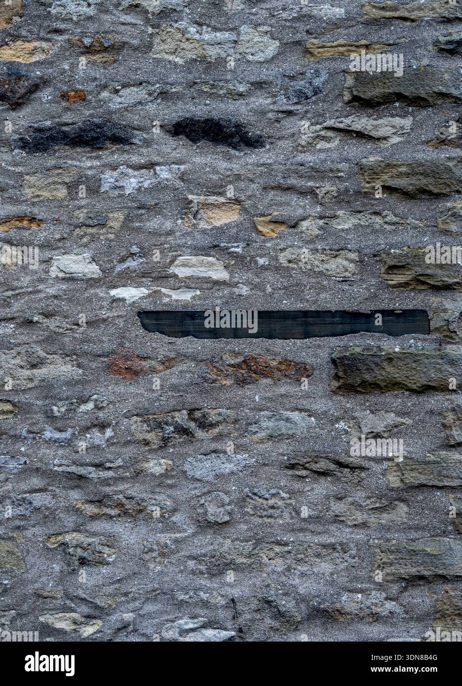 Grungy stone masonry forming a rough background surface. Stock Photo