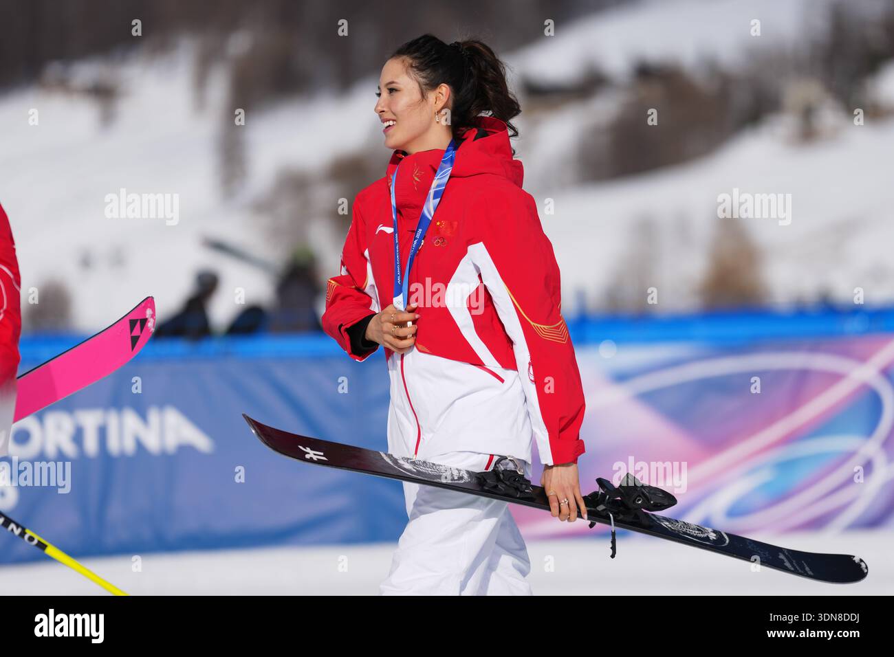 China's Eileen Gu walks with her ski and silver medal after the ...
