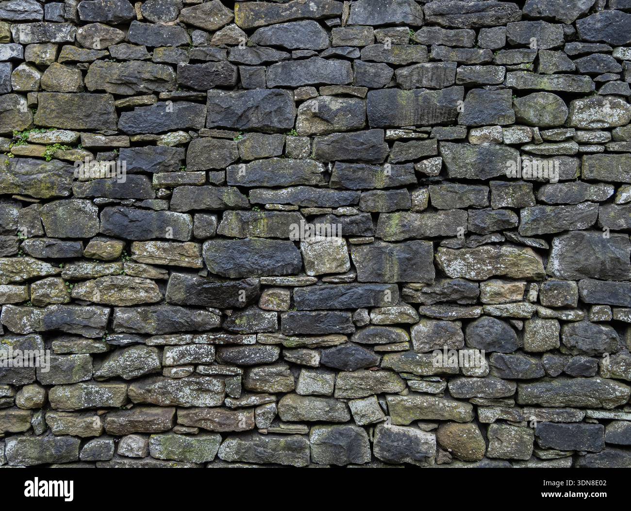 Moody Stone Facade Rough Texture Historic backdrop with black staining Stock Photo
