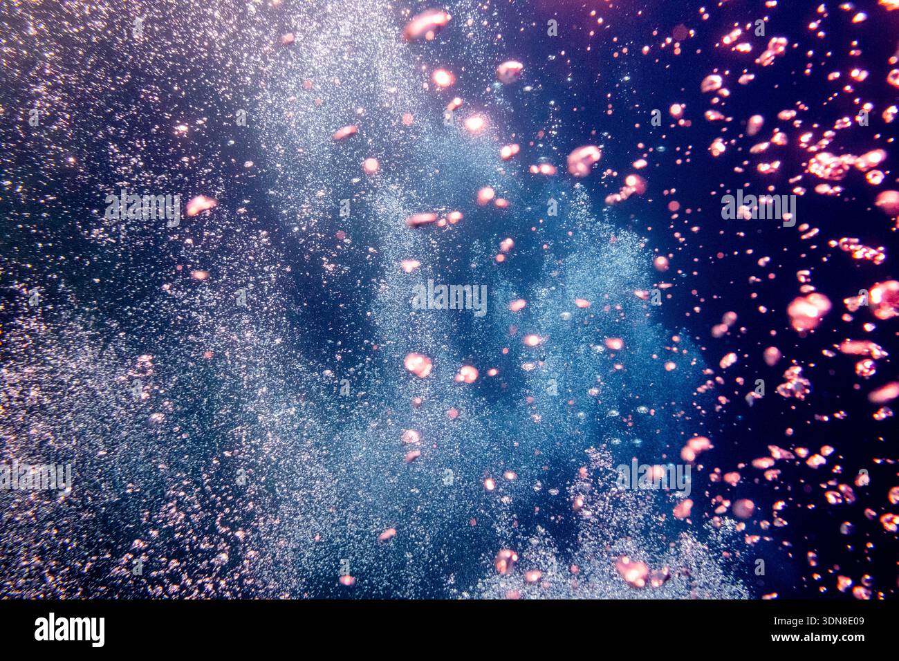 Abstract underwater view of countless bubbles and glittering particles ...