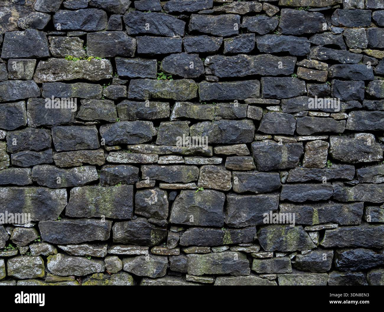 Grungy stone masonry forming a rough background surface. Stock Photo