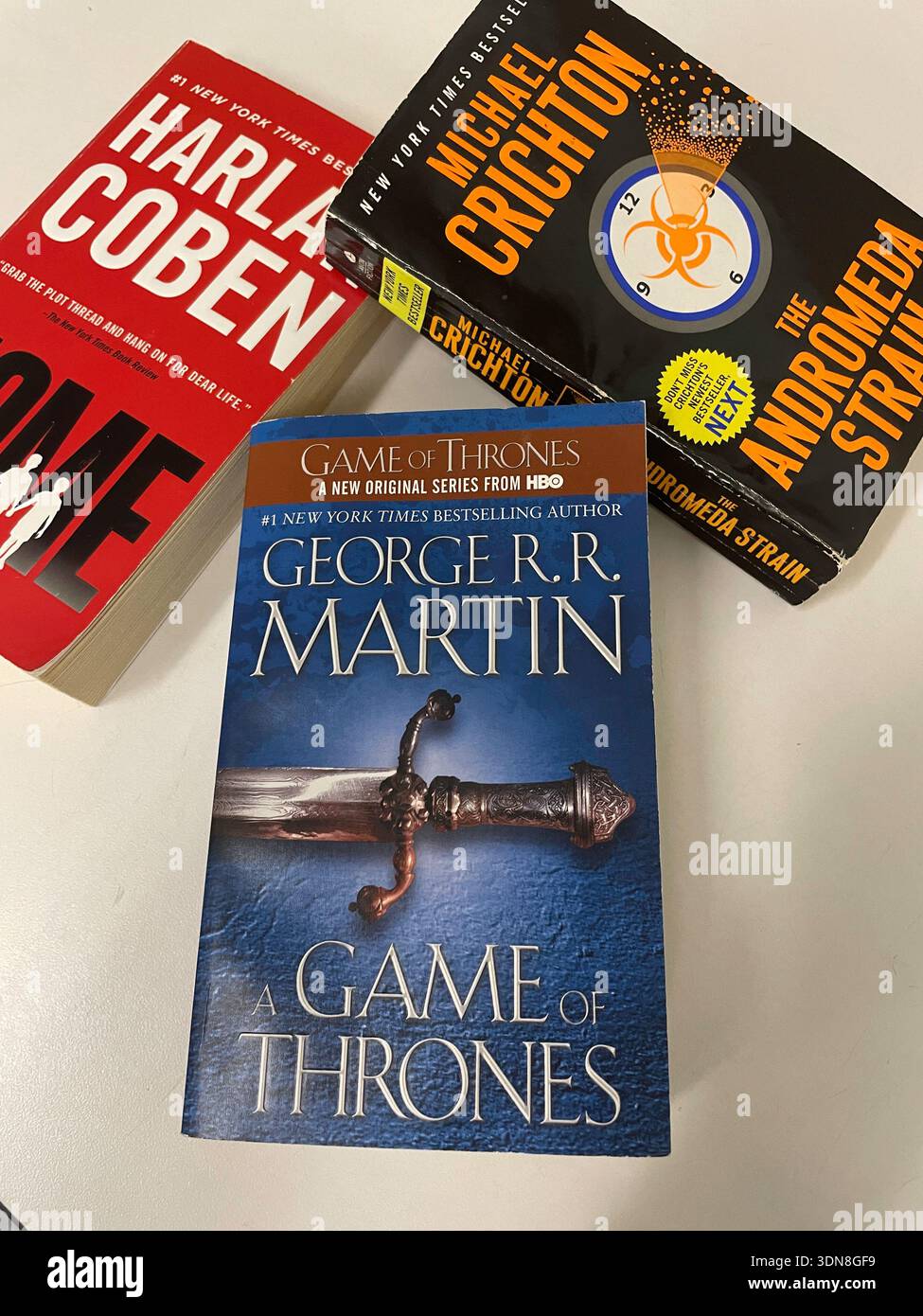 Still life of three best selling paperback novels on a white background, 2026, USA - Smartphone Captured Stock Image