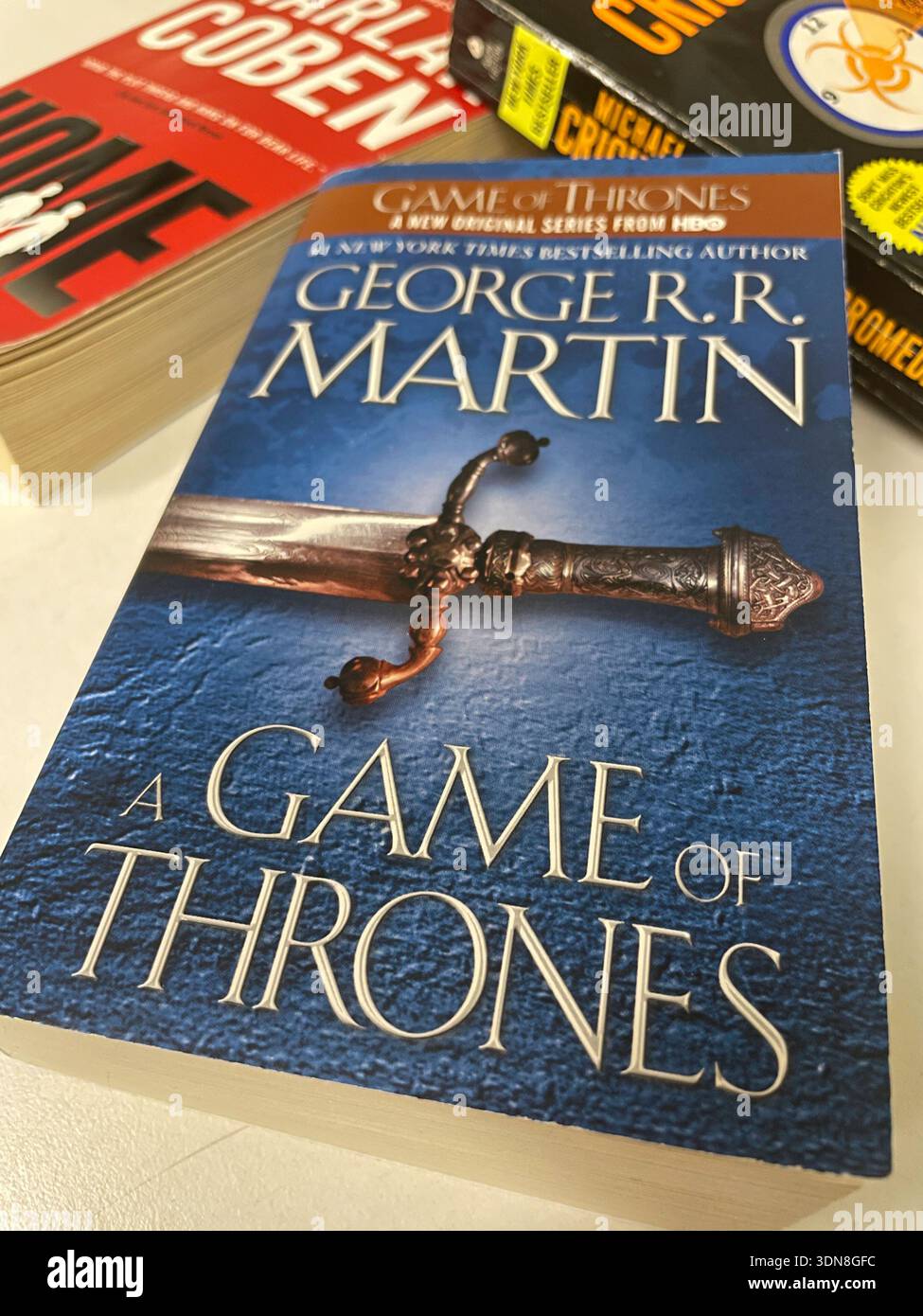 Still life of three best selling paperback novels on a white background, 2026, USA - Smartphone Captured Stock Image
