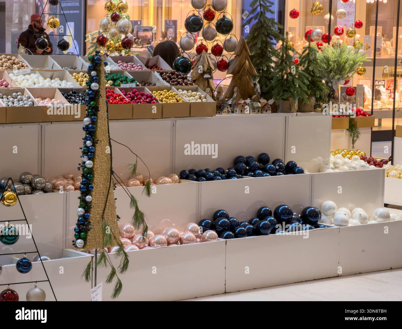A wide array of shimmering Christmas baubles, miniature trees, and ...