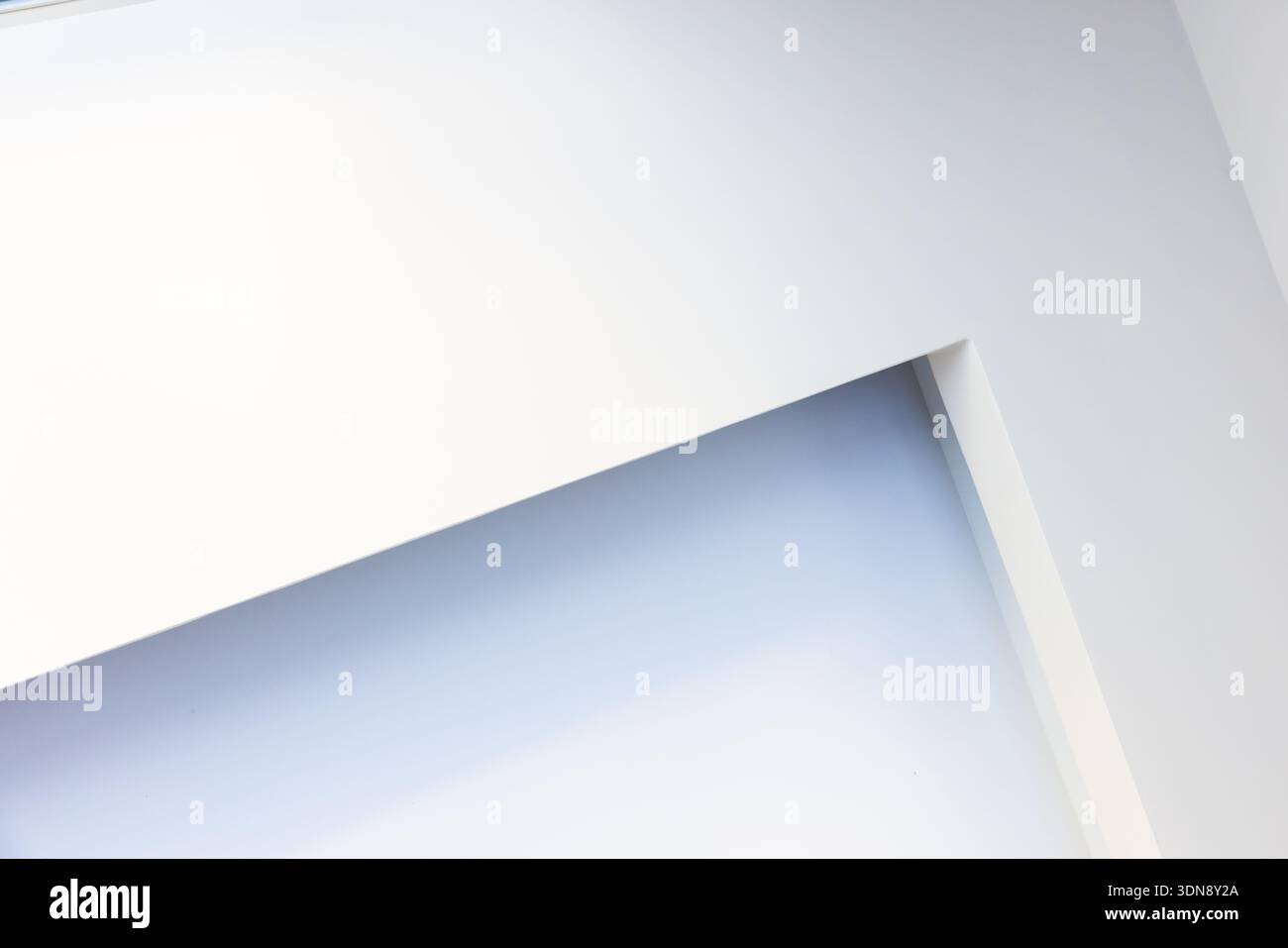 A clean, minimalist abstract composition featuring white and blue tones, diagonal lines, and sharp architectural panels. Evokes calm, modern space and Stock Photo