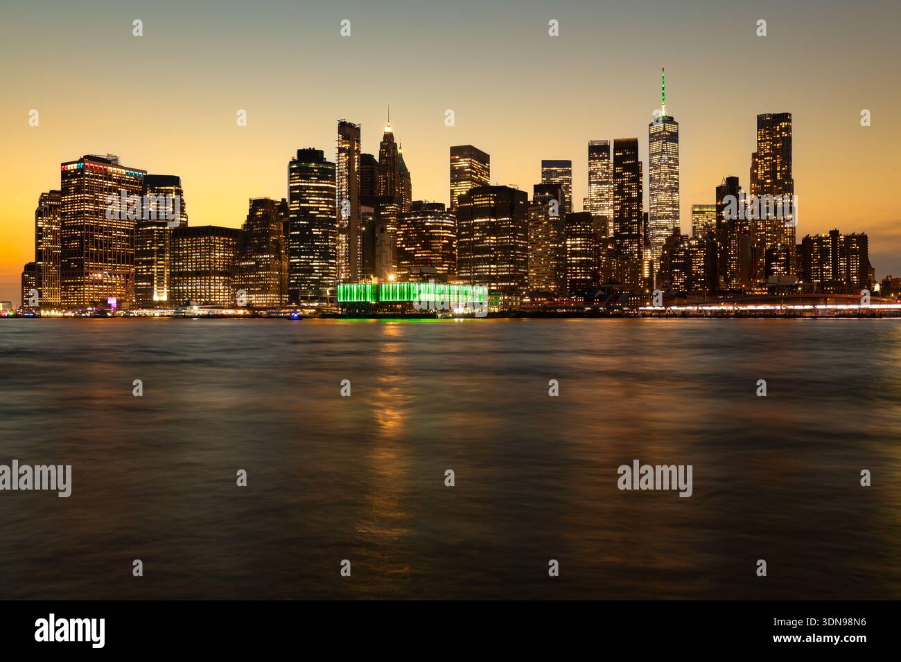 A stunning panoramic view of the Manhattan urban landscape captured from the Brooklyn waterfront at twilight, New York Stock Photo