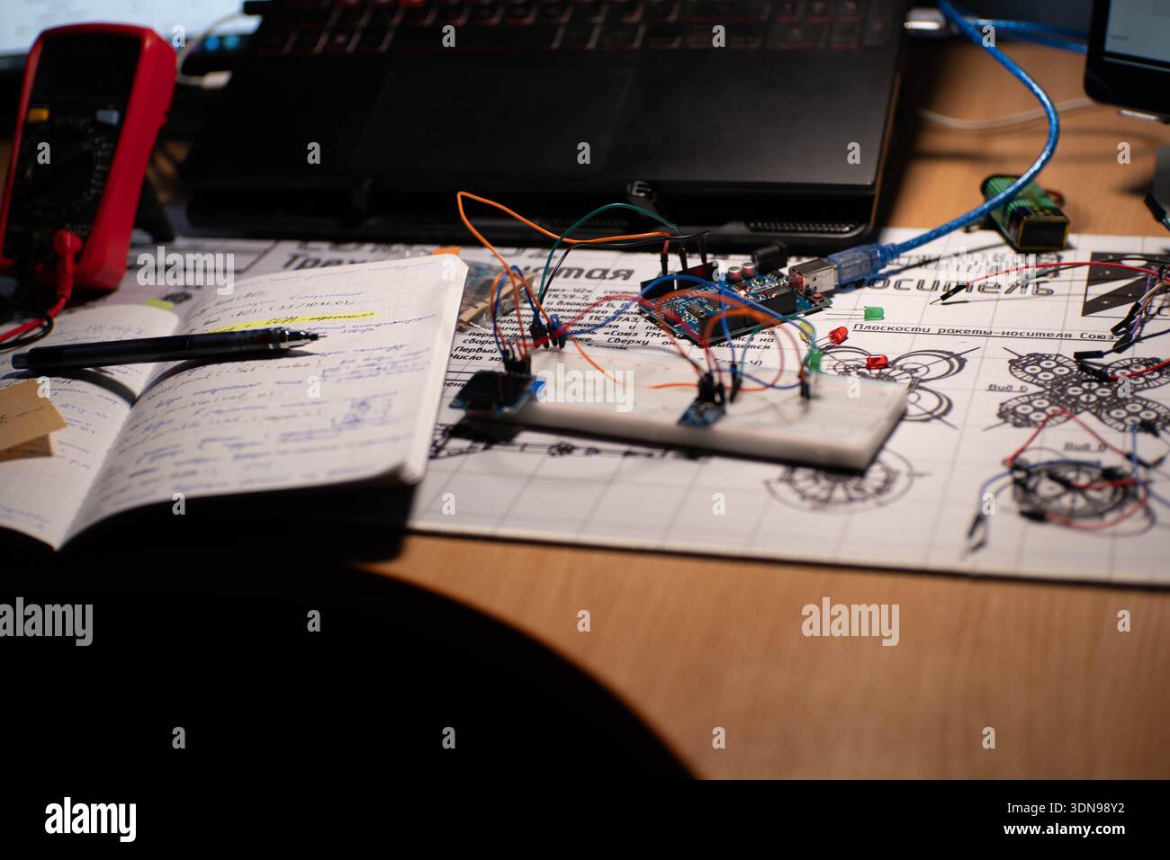 A detailed view of an electronics workbench setup, showing circuit ...