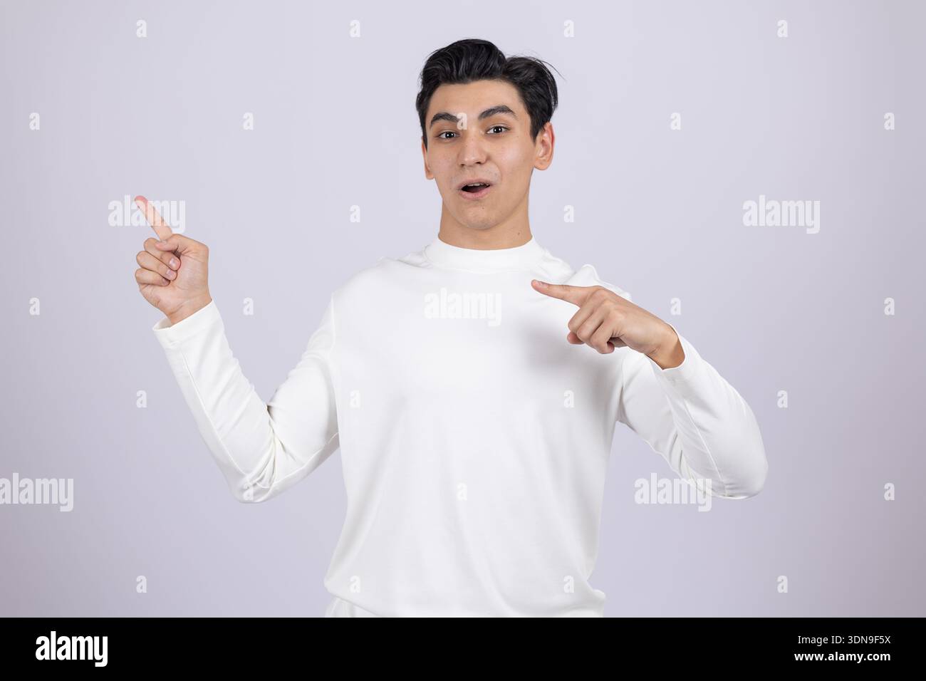 Young guy pointing fingers at himself in studio Stock Photo