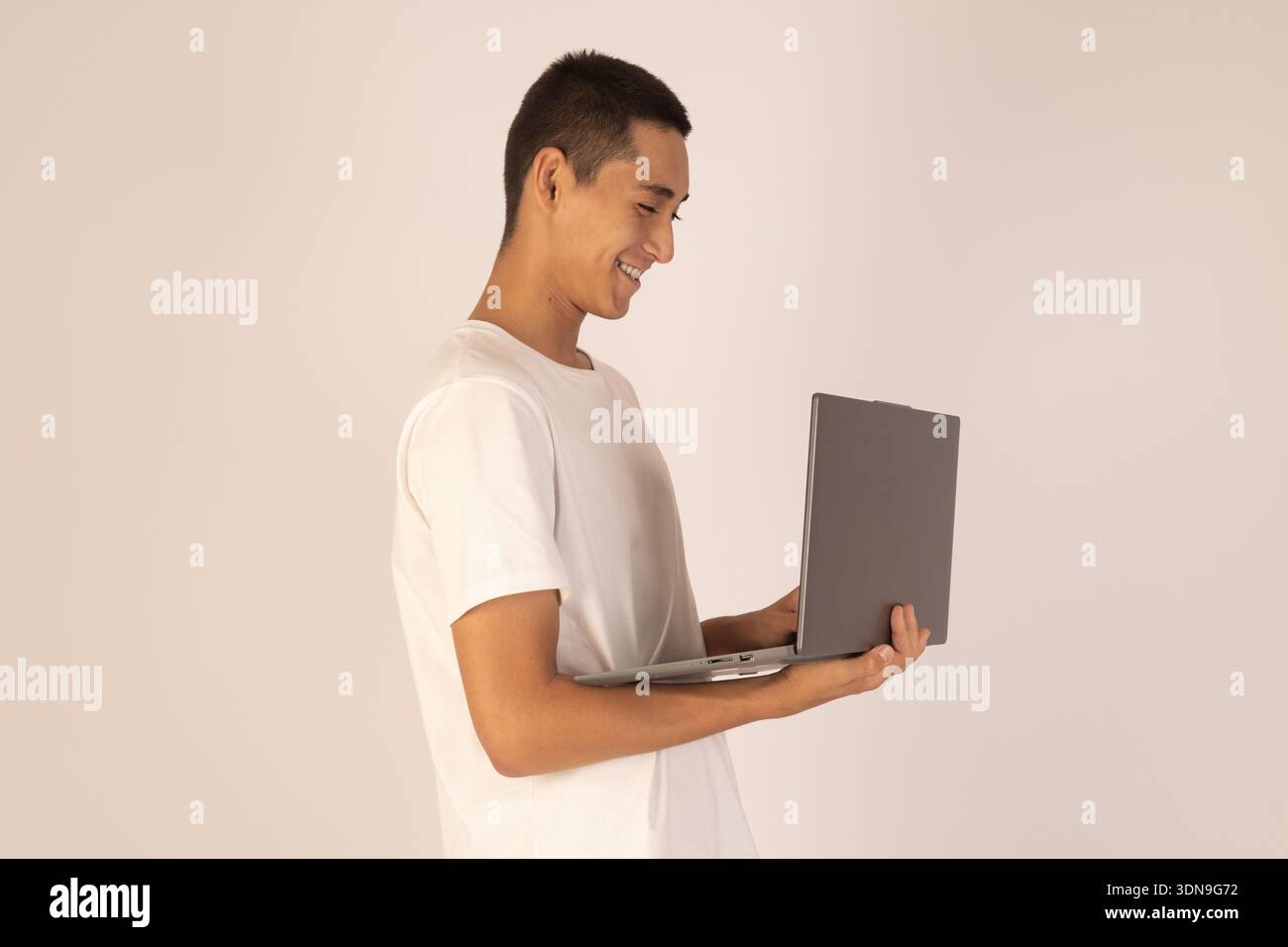 Man using laptop while standing on white background Stock Photo