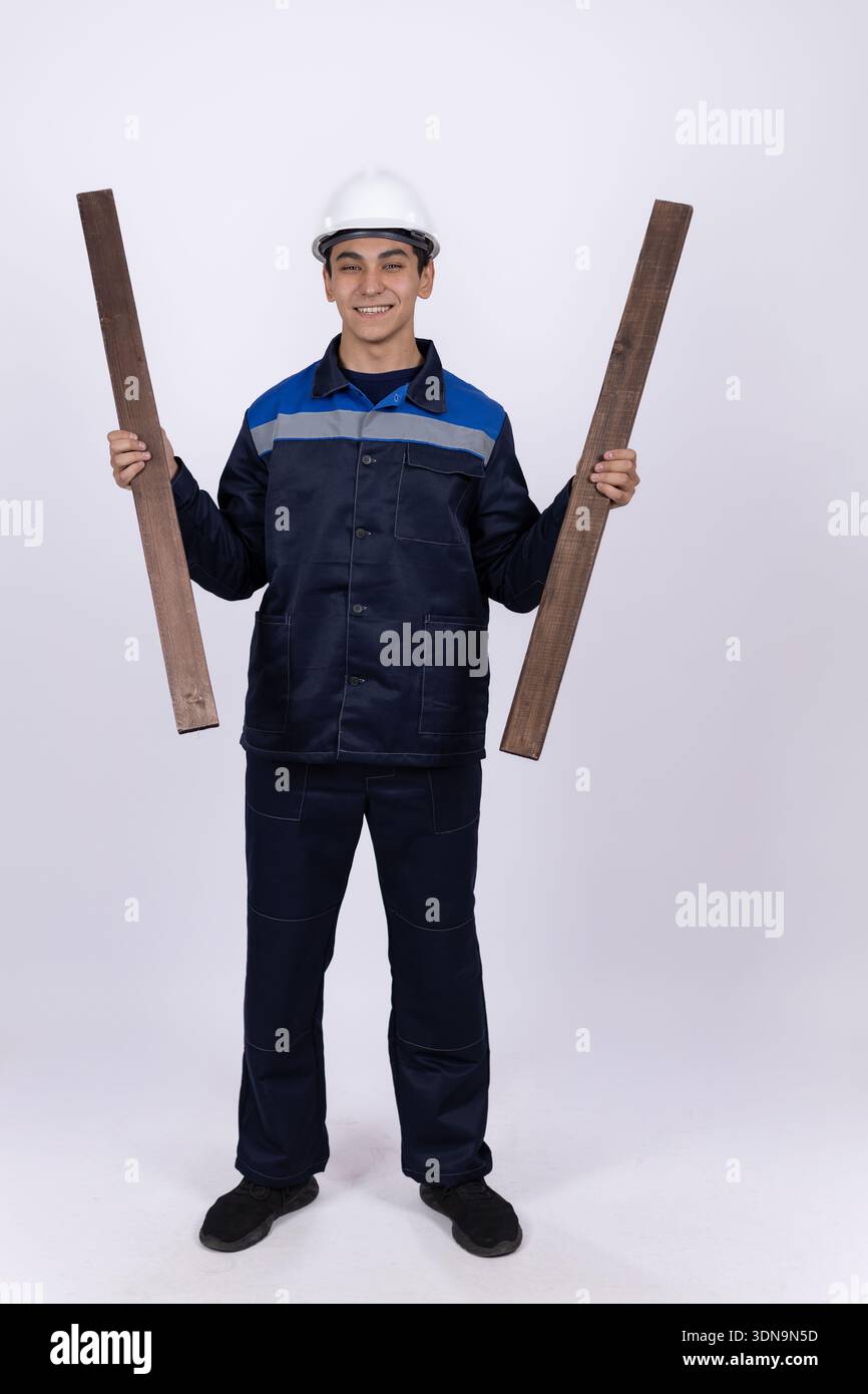 Man in work uniform holding large paper blueprints Stock Photo