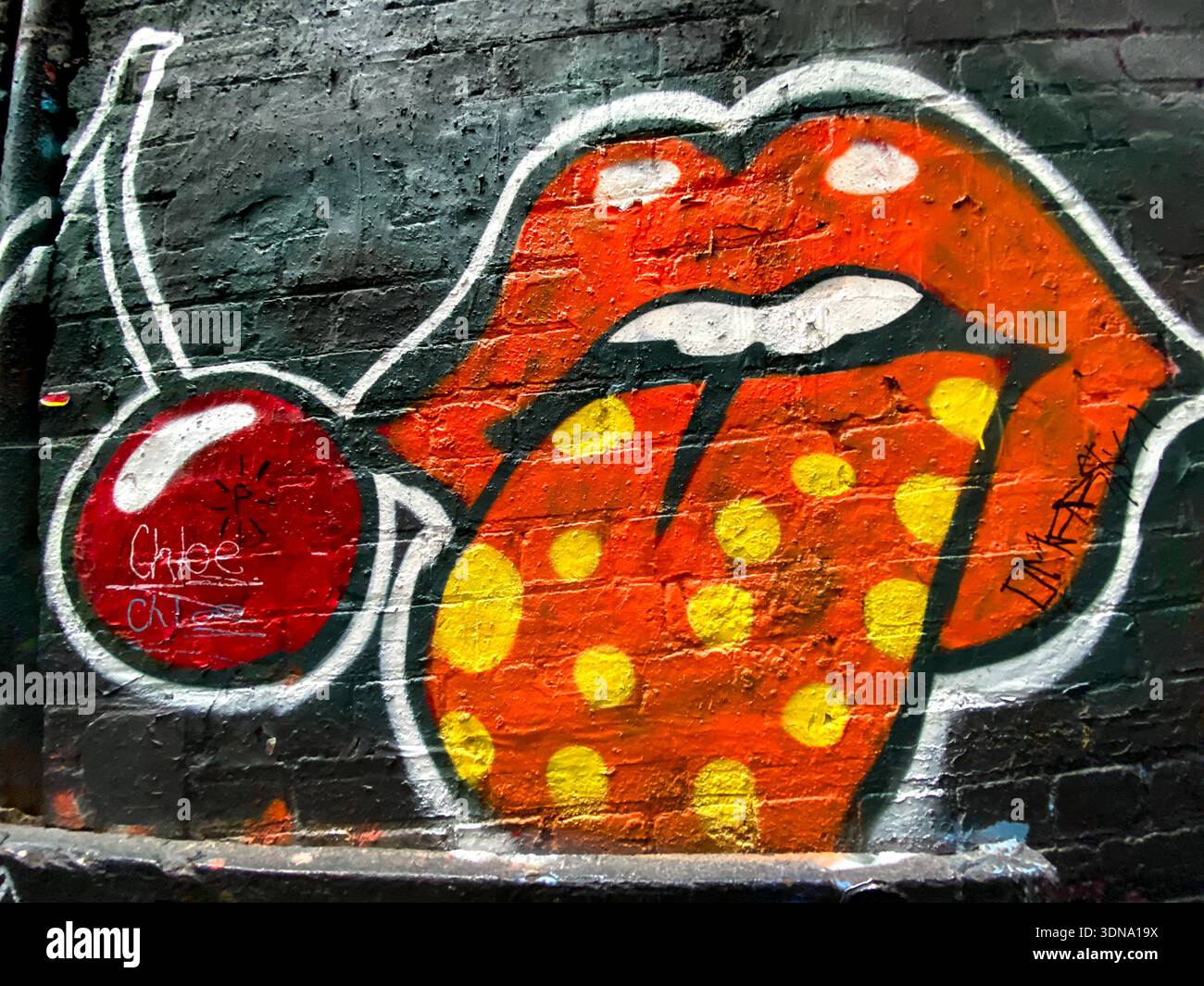 mural of red lips and cherry at AC/DC Lane in Melbourne, Australia - Smartphone Captured Stock Image
