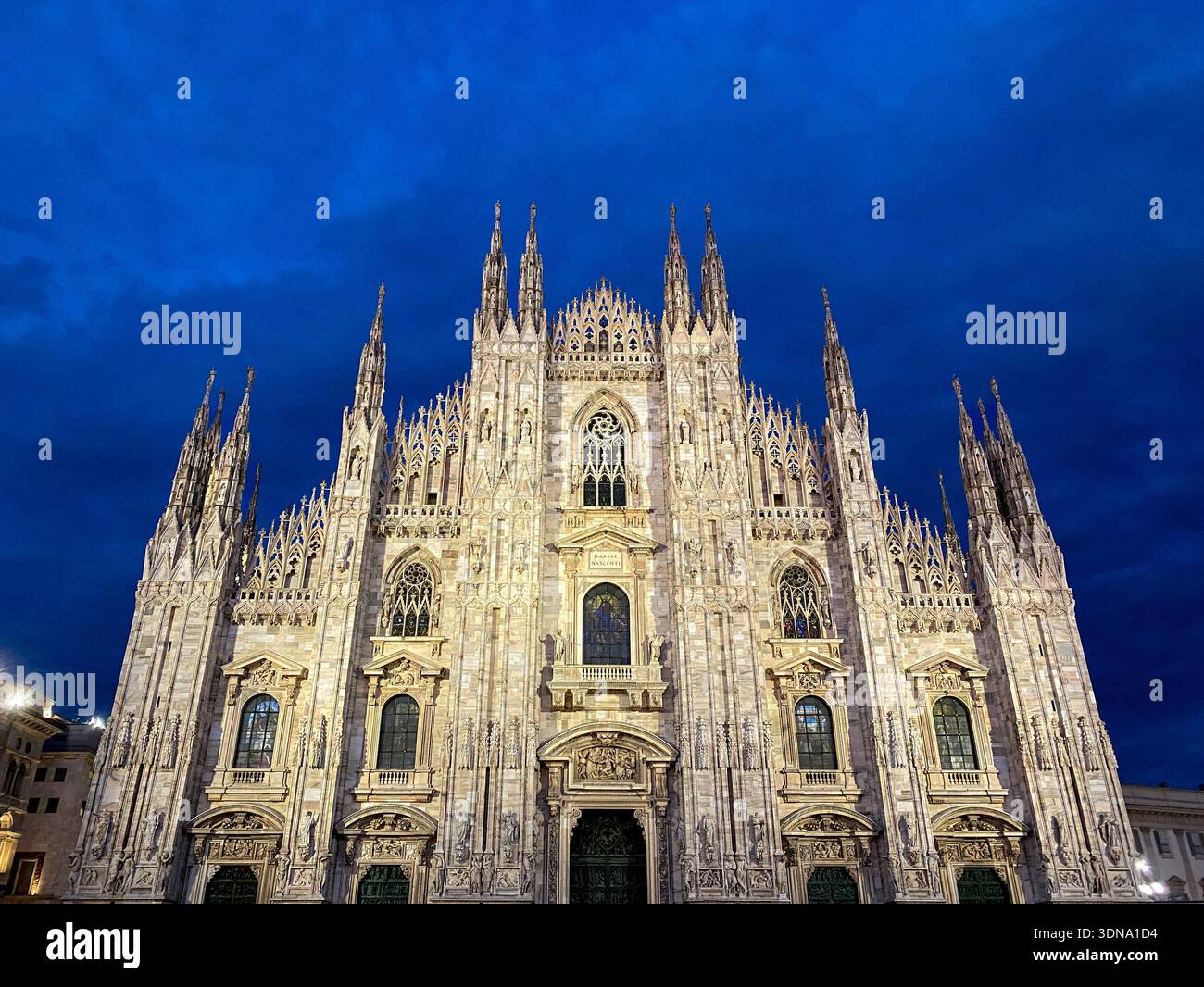 The facade of the Duomo di Milan at night. Milan, Italy - Smartphone Captured Stock Image