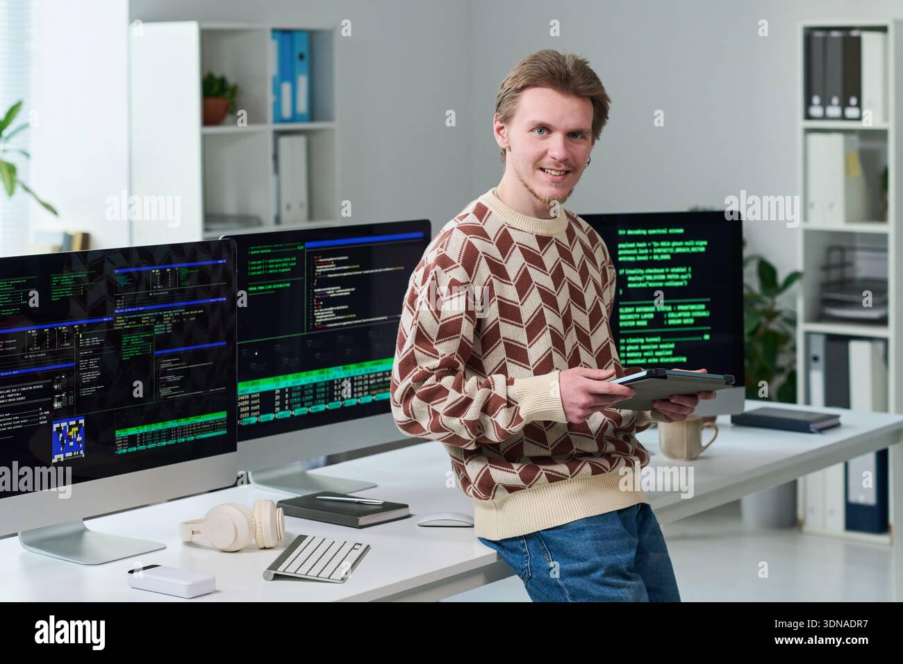 Young Man Using Digital Tablet While Working in Office Stock Photo