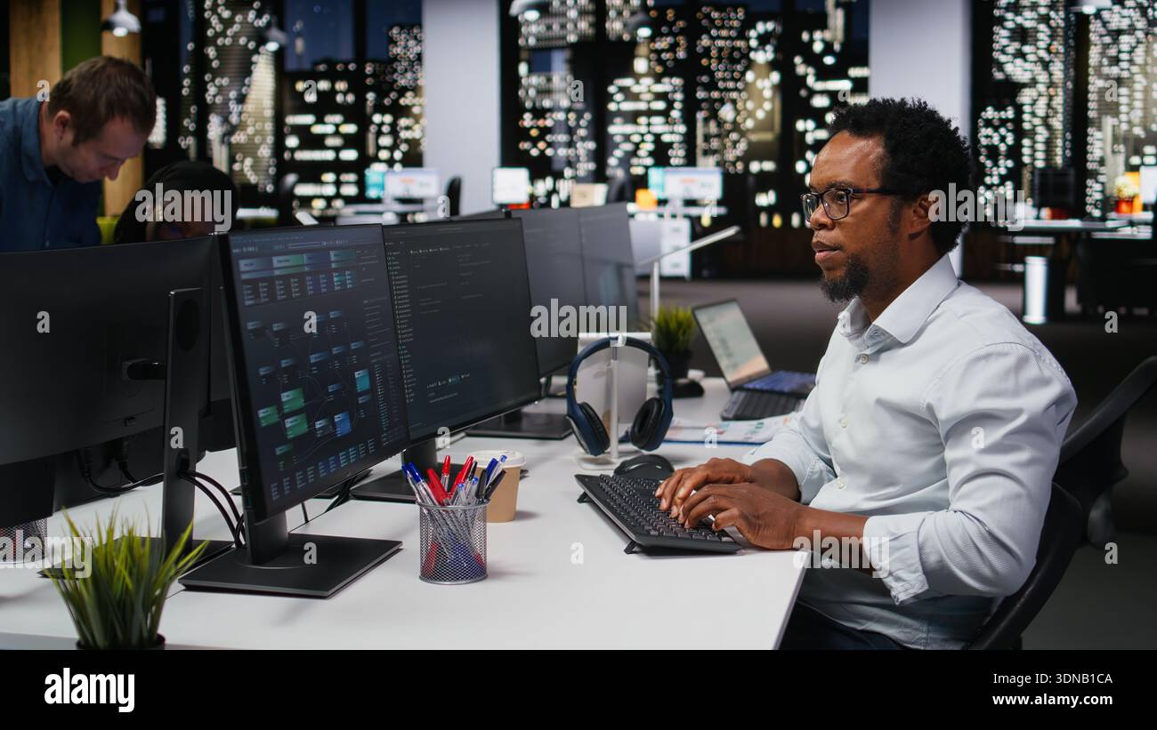 Engineer in Silicon Valley company office developing apps with AI. IT professional using machine learning to do coding, debugging applications to resolve issues Stock Photo