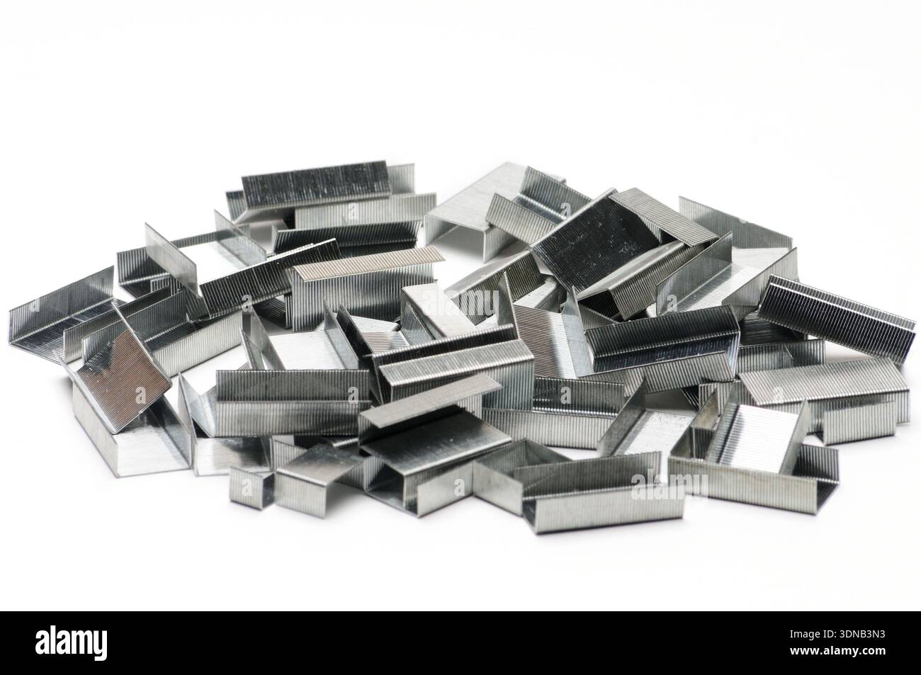 Paper clips from a stapler on an isolated white background Stock Photo