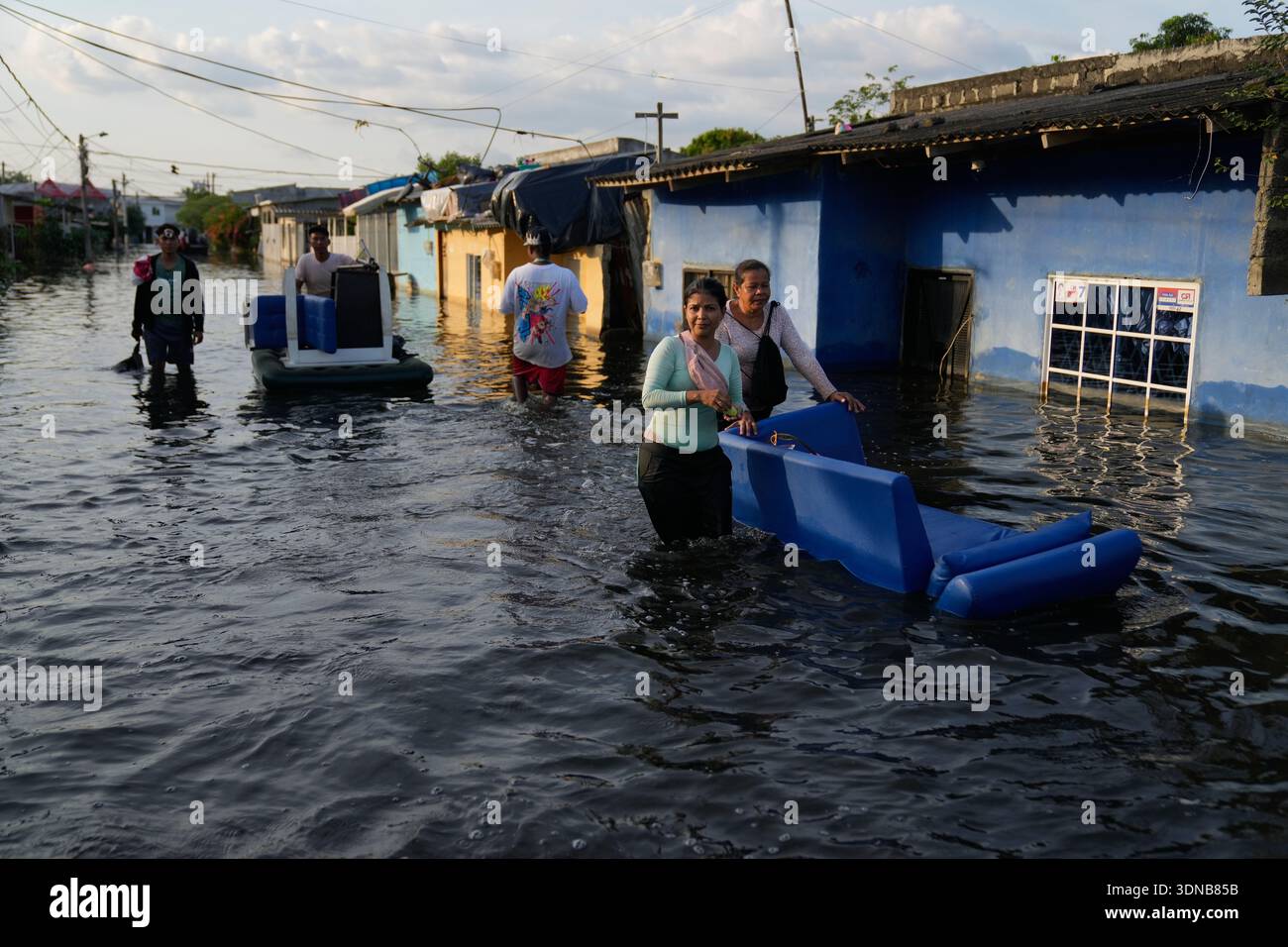 Residents recover belongings from flooded homes after rain caused the ...