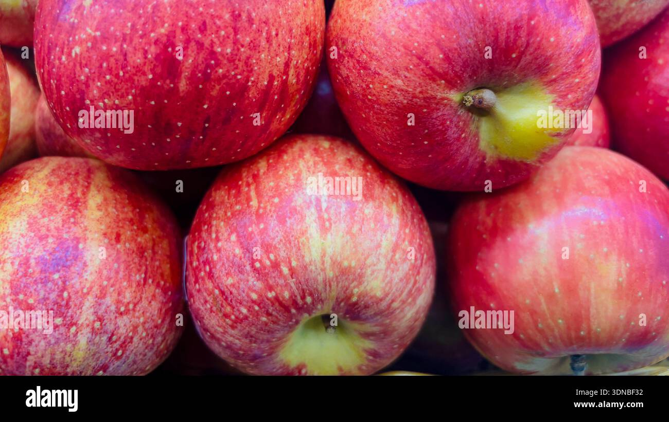 Close up view of fresh ripe red apples piled together showing natural texture and vibrant color suitable for food backgrounds. - Smartphone Captured Stock Image