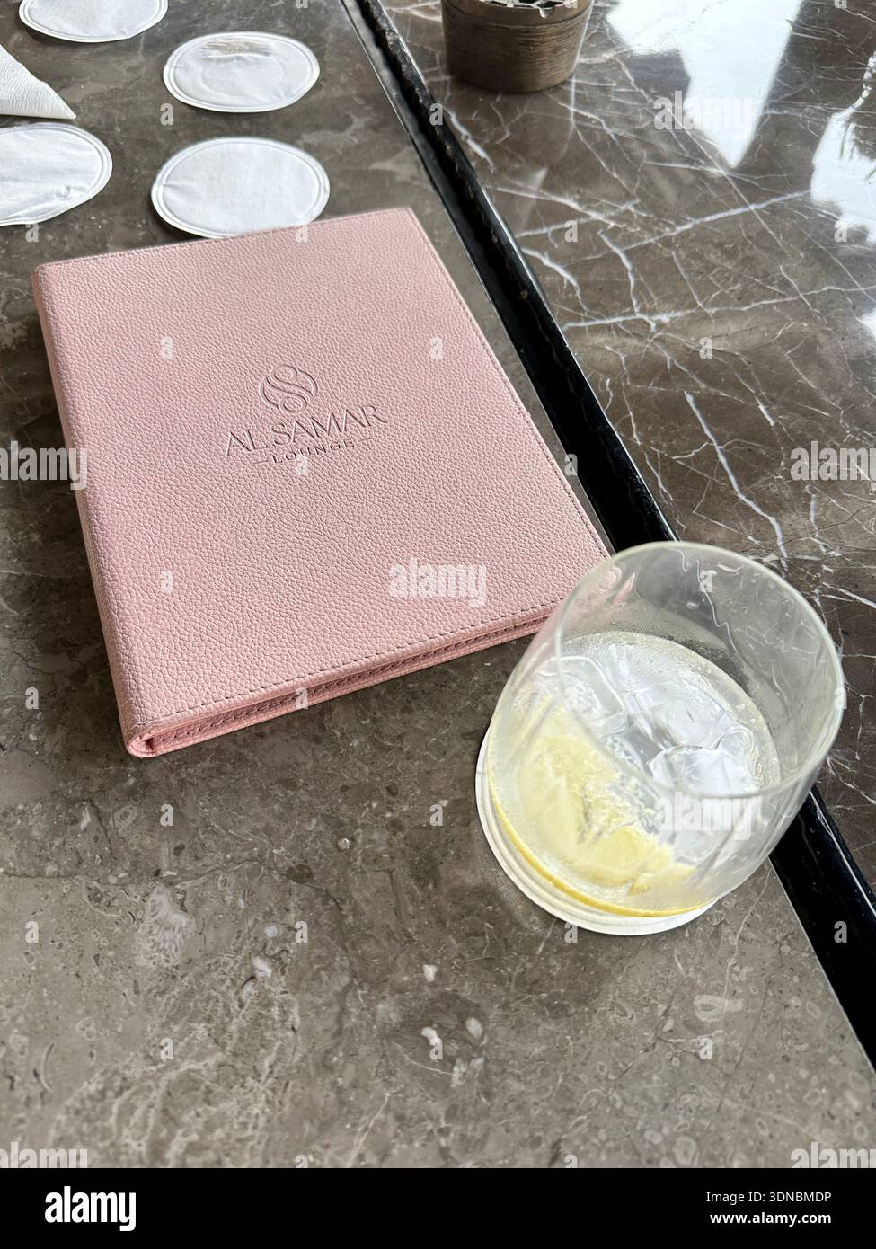 Glass of water on table with menu madinat hotel bar Stock Photo