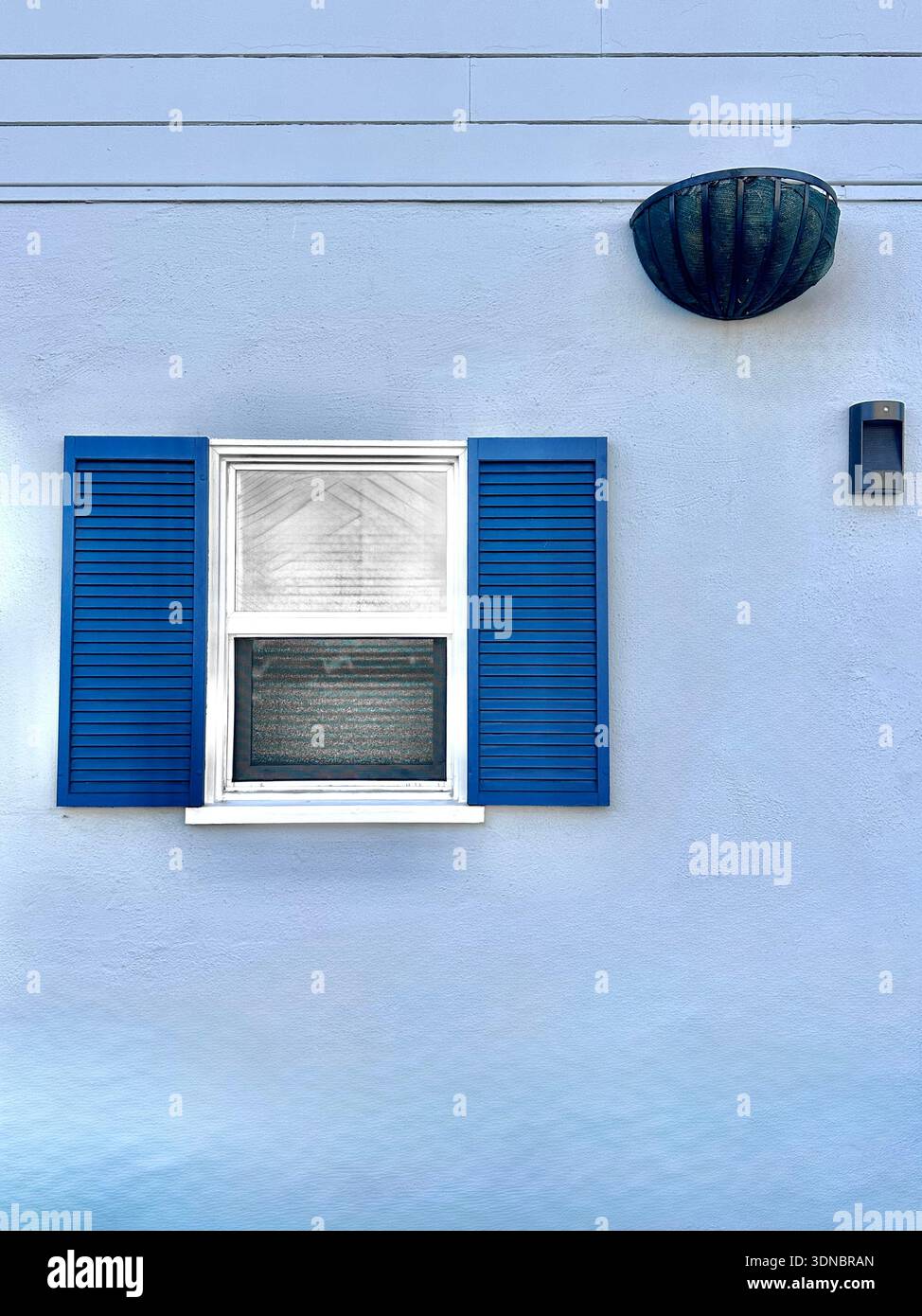 Minimalist Blue House Exterior with Window and Shutters - Smartphone Captured Stock Image